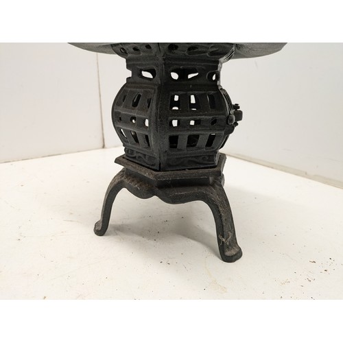 404 - A Cast Iron Oriental Candle Holder