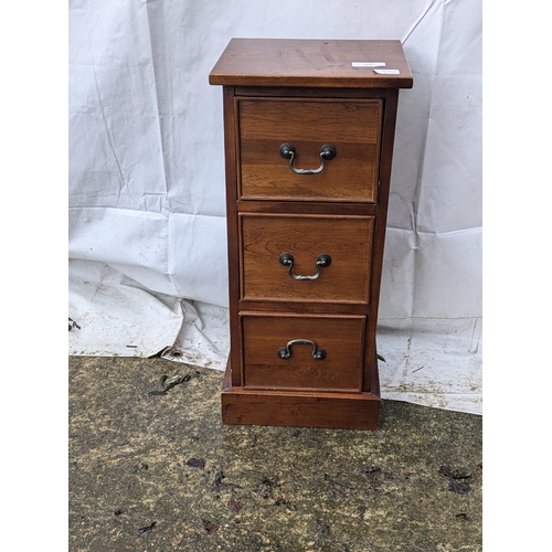 206 - A small Oak veneered bedside table with 3 drawers and brass handles