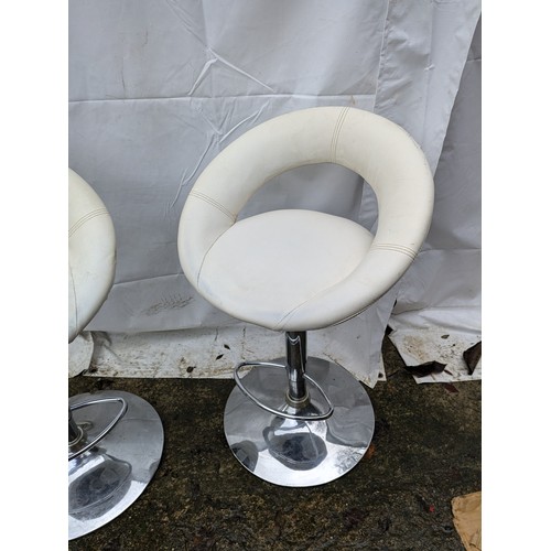 215 - A pair of cream leather and stainless steel bar stools