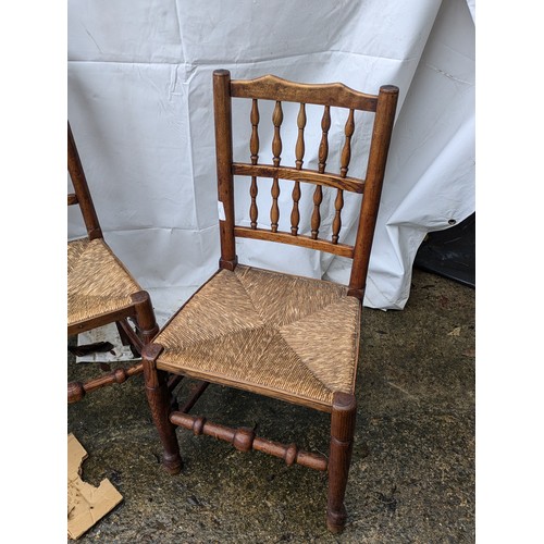 221 - A Pair of Oak Chairs With Spoked Back and Wicker Seats