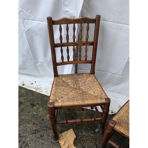 221 - A Pair of Oak Chairs With Spoked Back and Wicker Seats