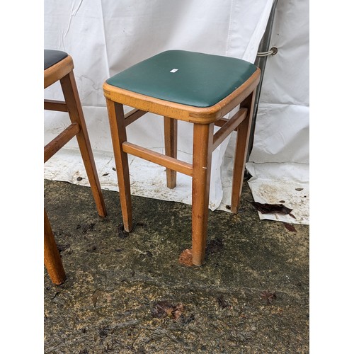 207 - A pair of 70s stools with leather seat bases