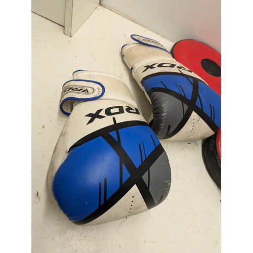 1038 - A Pair of Red and black boxing pads and RDX 12 ounce Gloves