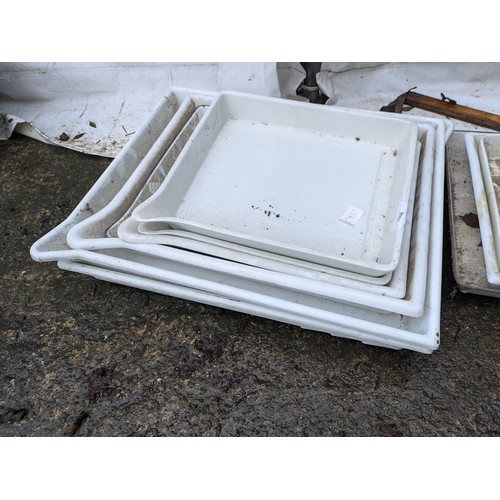 1008 - A Group of Plastic and Cast Iron Farmhouse Style Trays