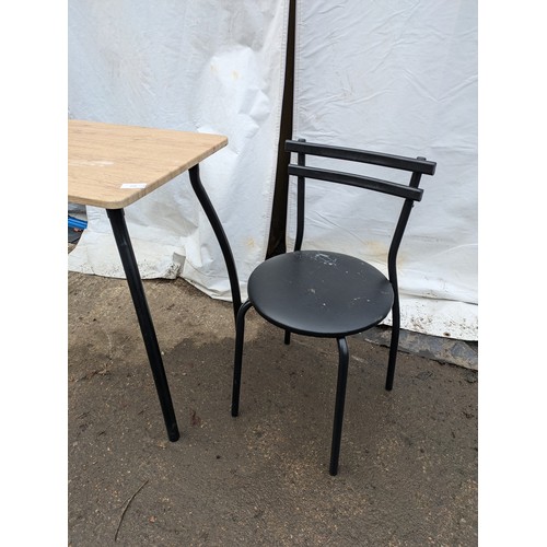 274 - a modern lightweight black topped table with a light wood effect top and 2 chairs