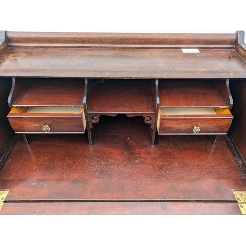 279 - an antique oak bureau with 2 internal and 1 external drawers, and brass handles