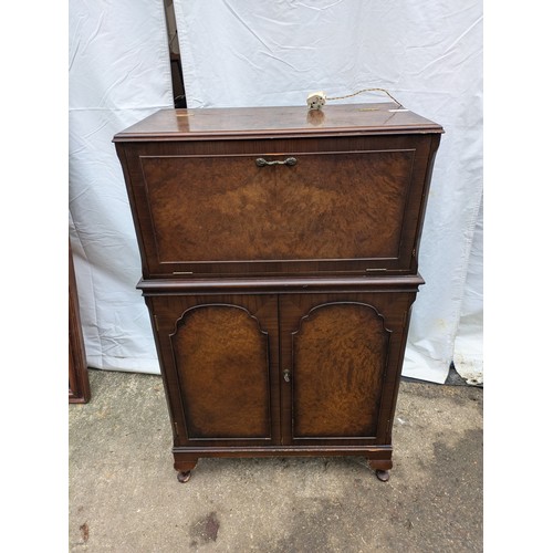 284 - a verniered oak drinks cabinet with brass handles