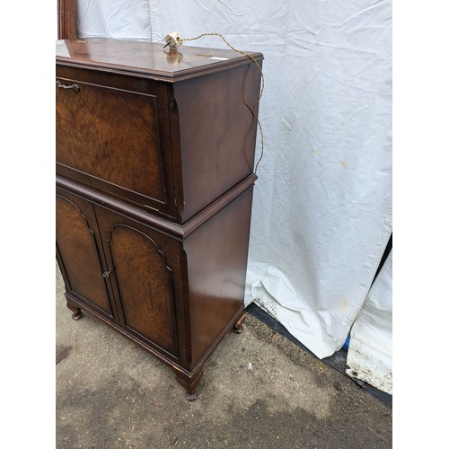 284 - a verniered oak drinks cabinet with brass handles