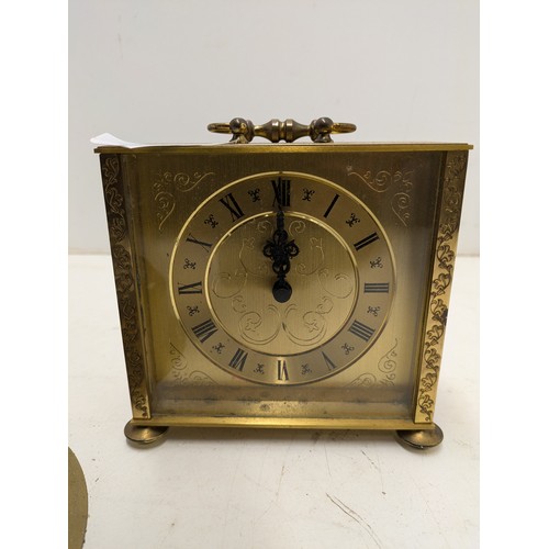 489 - A Pair Of Brass Quartz Clocks , One With Ornate Engravings