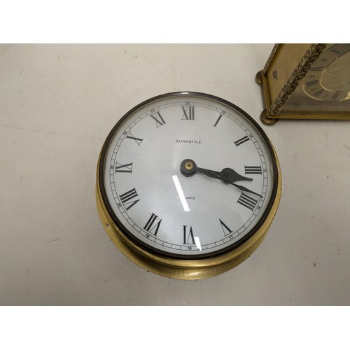 489 - A Pair Of Brass Quartz Clocks , One With Ornate Engravings