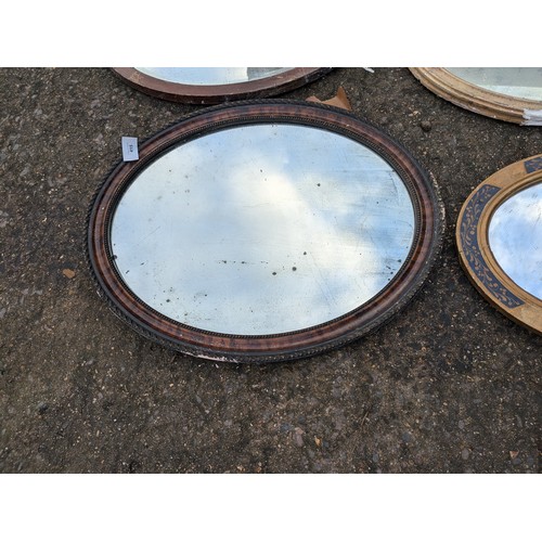 521 - a selection of vintage oval mirrors including guilded and verniered frames