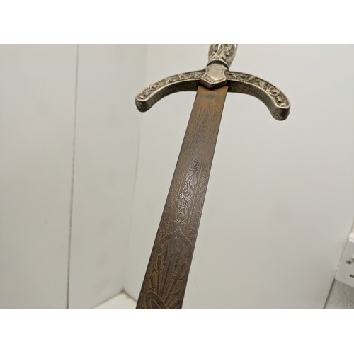 528 - A decorative dress swords with detail to the blade, and a carving of a woman to the handle