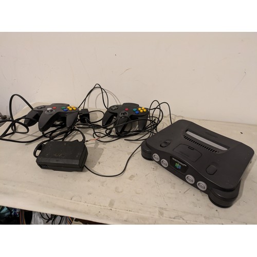 A Nintendo 64 Console With 2 Controllers and Cables