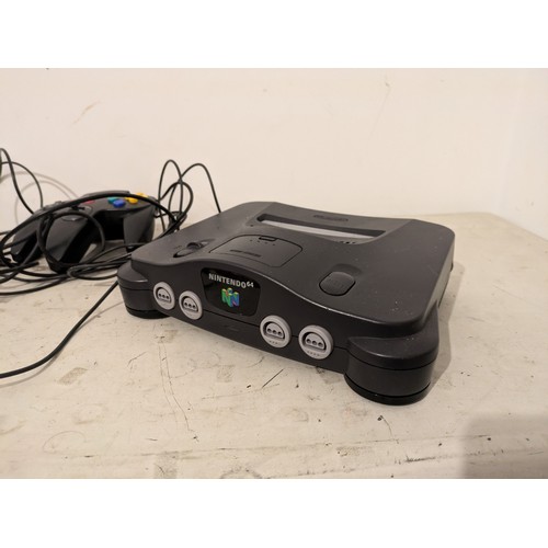 A Nintendo 64 Console With 2 Controllers And Cables