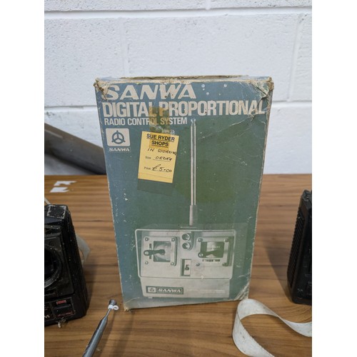 639 - A Selection of 5 RC Handheld Remotes including a Boxed Sanwa Mini Propo