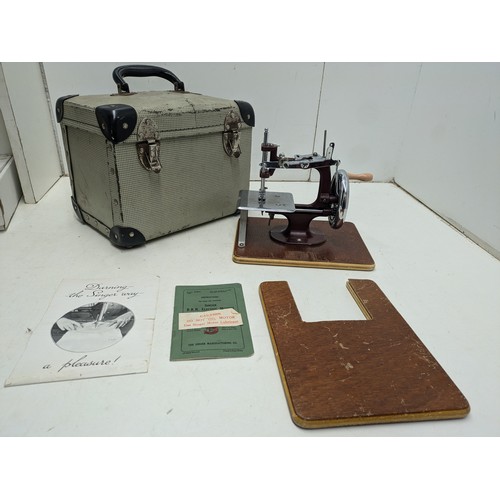 423 - A Vintage Miniature Sewing Machine In Carry Case