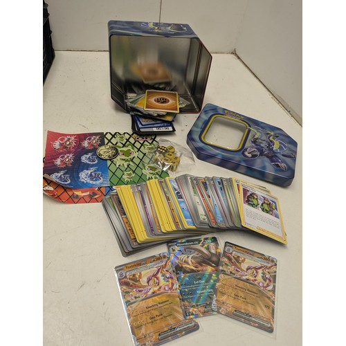 1020 - A large selection of Pokemon cards and accessories in a Pokemon storage tin