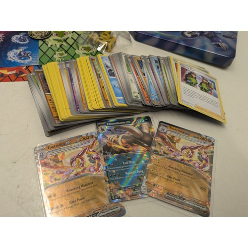 1020 - A large selection of Pokemon cards and accessories in a Pokemon storage tin