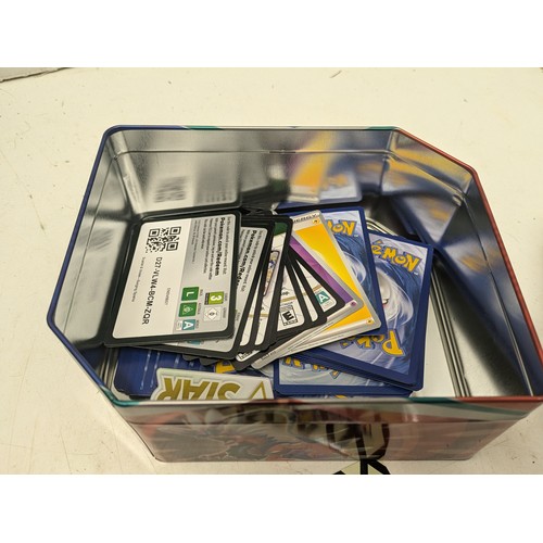 1020 - A large selection of Pokemon cards and accessories in a Pokemon storage tin