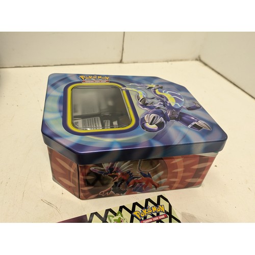 1020 - A large selection of Pokemon cards and accessories in a Pokemon storage tin