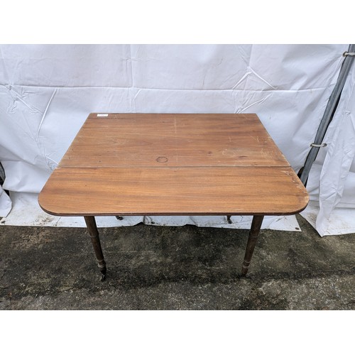 266 - A Late 19th Century Drop Leaf Table With 1 Drawer And Brass Castors