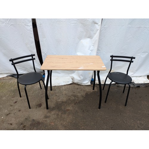 274 - a modern lightweight black topped table with a light wood effect top and 2 chairs