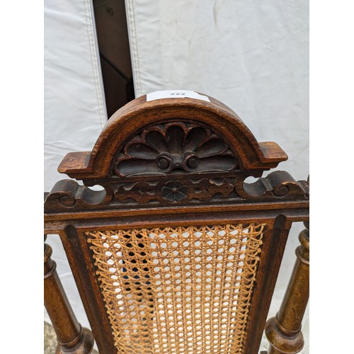 276 - a pair of antique chairs - stained oak, one rural design and one ornate with wicker base and back