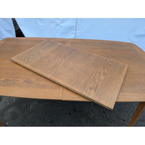 283 - a retro style verniered oak dining table with removable extension