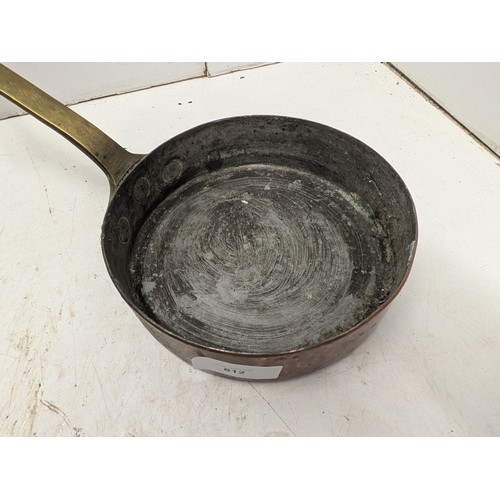 812 - An antique hand hammered copper and brass saucepan