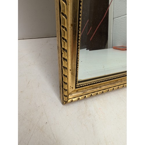 405 - A beveled edged mirror in a gold guilt frame