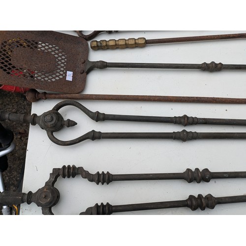 884 - A selection of brass and wrought iron fireside equipment and rods