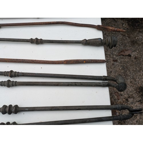 884 - A selection of brass and wrought iron fireside equipment and rods