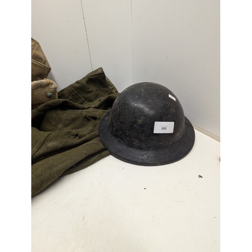 880 - A selection of military clothing and equipment including helmet bag and trousers