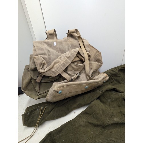 880 - A selection of military clothing and equipment including helmet bag and trousers