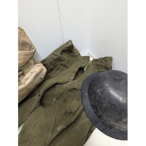 880 - A selection of military clothing and equipment including helmet bag and trousers