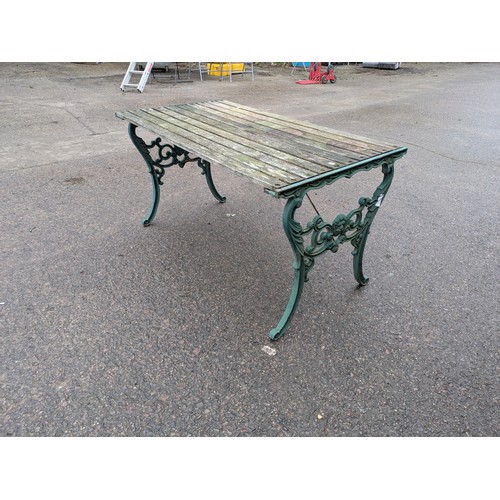 11 - An Outdoor Garden table with wood top and cast iron legs