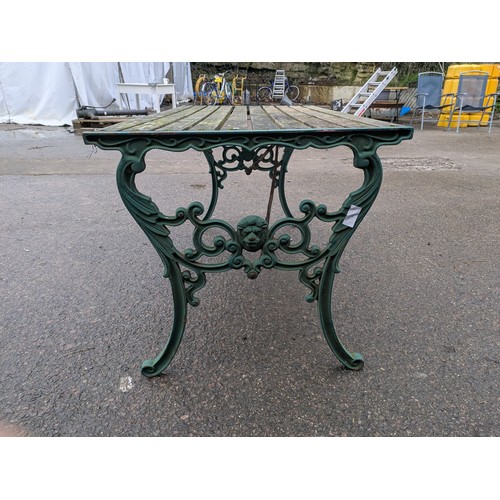 11 - An Outdoor Garden table with wood top and cast iron legs