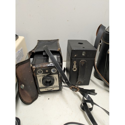 1046 - A Large Selection of vintage camera equipment in cases