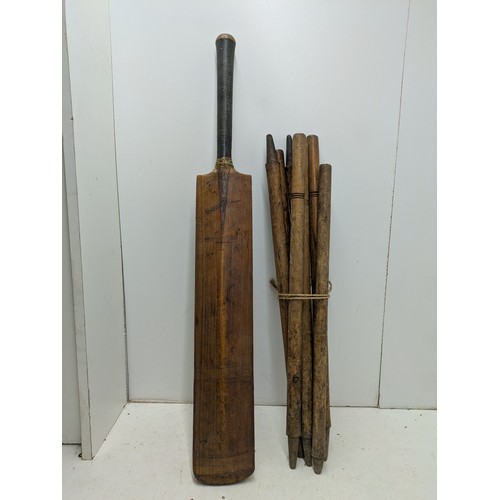 1010 - A Vintage Oak Cricket Bat with 7 Cricket Posts