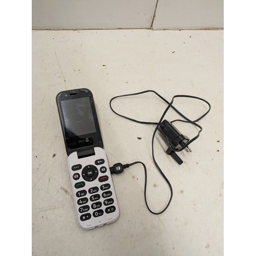 1410 - A Doro Flip Phone with Charger - Powers on