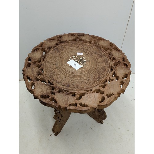 607 - A Carved oak inlaid table with floral patternation