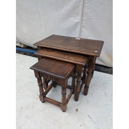 613 - A nest of tables - stained oak - early 20th Century