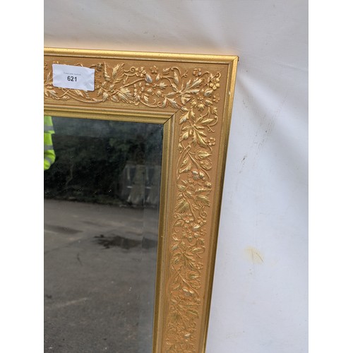 621 - A Large bevelled edged mirror in a guilded floral frame