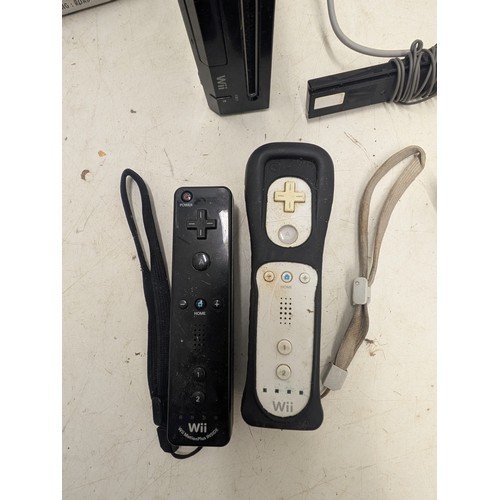 1424 - A Nintendo Wii Console With cables, controllers and a selection of games