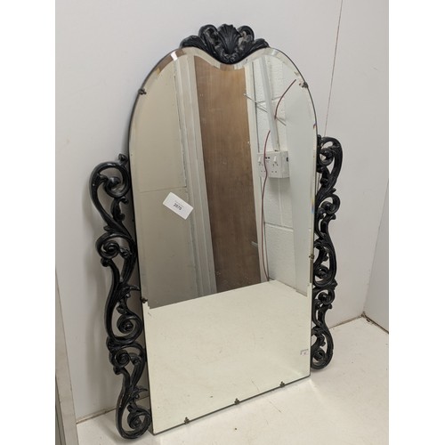 2070 - A large cast iron styled circa 1970s bevelled mirror