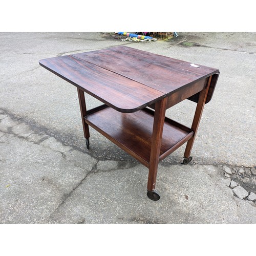 404 - A British made Pine drop leaf table on casters - plaque underneath for E&S Quality British Made