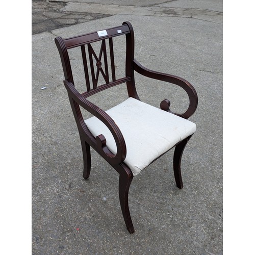 423 - An Oak Armchair With Spoke Detail and Cream Upholstered Seat