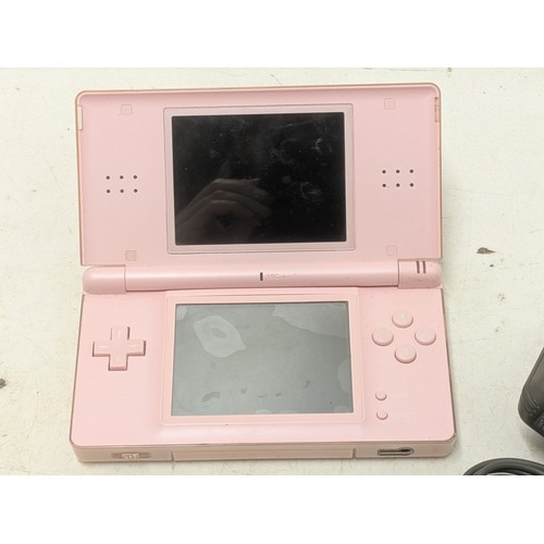 1516 - A pink Nintendo DS Console With Charger and 4 Games - Working