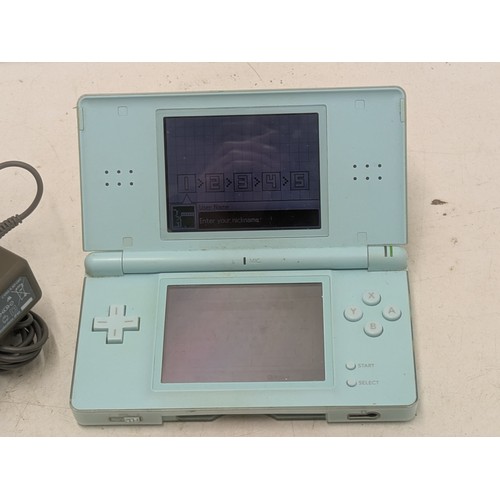 1517 - A blue Nintendo DS Console With Charger and 4 Games - Working