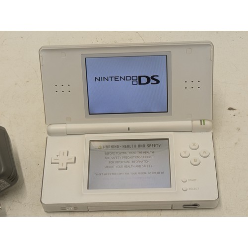 1518 - A white Nintendo DS Console With Charger and 4 Games - Working